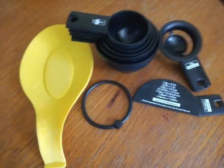 Photo of free Black plastic cup measures, and a yellow silicon spoon rest (St Helens TN35) #1