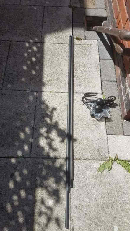 Photo of free 2 black curtain poles & hold backs (Astley CV10) #1