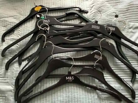 Photo of free Lot of 15 black plastic clothes hangers (BT10) #1