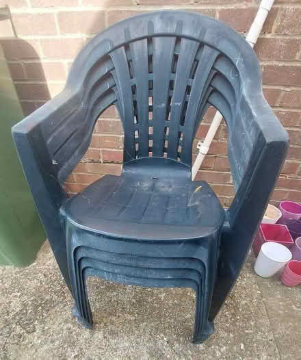 Photo of free 4 plastic dark green garden chairs (Seaford BN25) #1