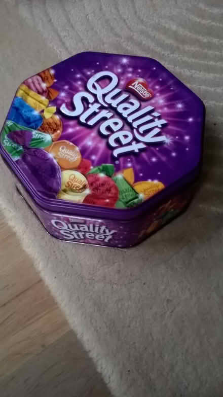 Photo of free Metal quality street tin and two plastic celebration tubs (Horspath OX33) #1