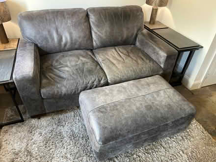 Photo of free Grey leather sofa with pouffe (High fields Tetbury) #1