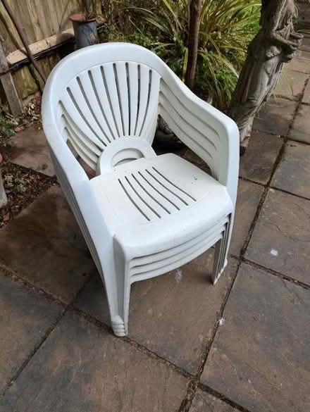 Photo of free Four white plastic garden chairs (West Byfleet GU22) #1