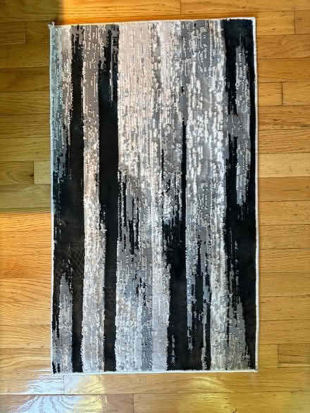 Photo of free Small black & white rug (Hollenbeck and Remington) #1