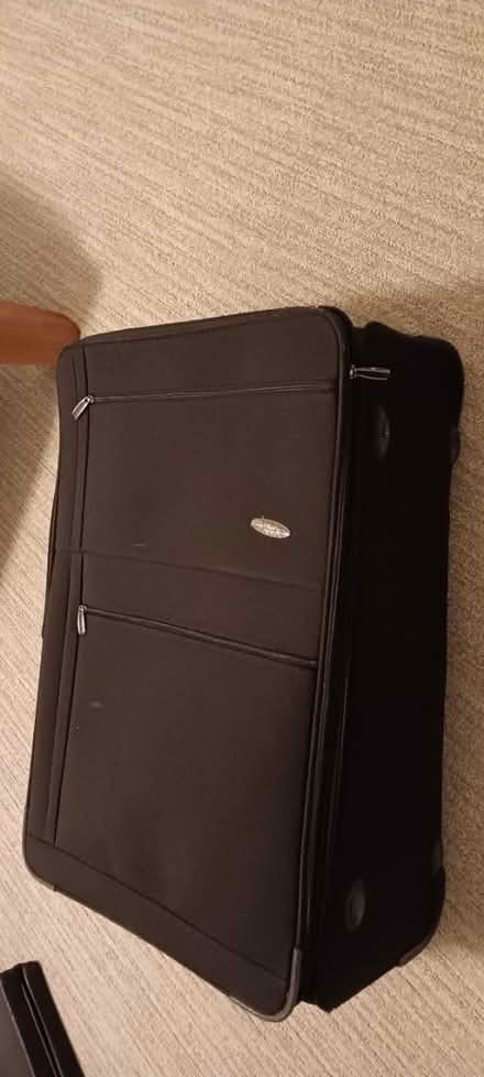 Photo of free Large rolling black suitcase (Downtown Berkeley) #1