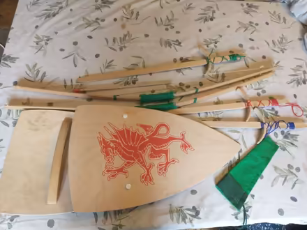 Photo of free English heritage 3 wooden swords, 2 shields, 2 bows/arrows (Wood Green N22) #1