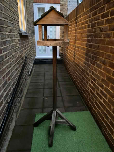 Photo of free Wooden bird table, bird seed, 2 bird feeders (Fulham Palace Rd SW6) #1