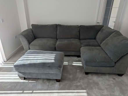 Photo of free Grey L-shaped sofa and footstool (Biggleswade SG18) #1