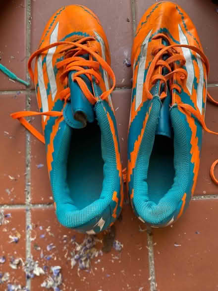 Photo of free Orange + blue rugby boots Size 10 (Heath) #1