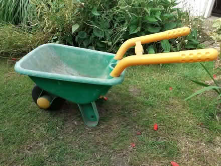 Photo of free Child's green and yellow plastic wheelbarrow (Wandsworth Common SW12) #1