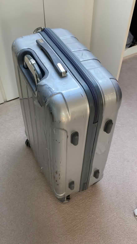 Photo of free Silver 4 wheel suitcase. Superficial defect to outside (Southfields SW18) #1