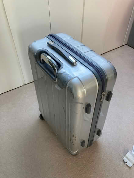 Photo of free Silver 4 wheel suitcase. Superficial defect to outside (Southfields SW18) #2