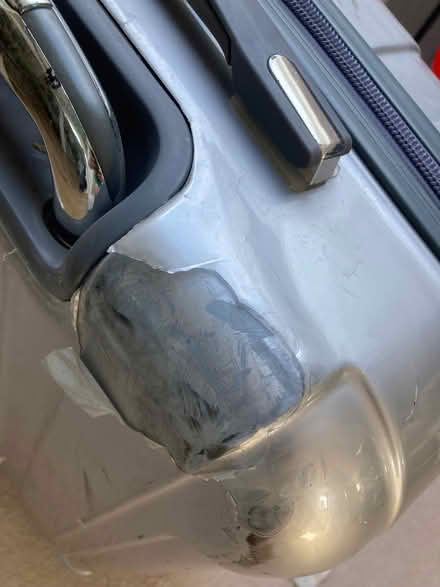 Photo of free Silver 4 wheel suitcase. Superficial defect to outside (Southfields SW18) #3