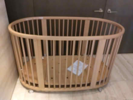 Photo of free Light brown wood oval crib, wheels (Upper West side) #2
