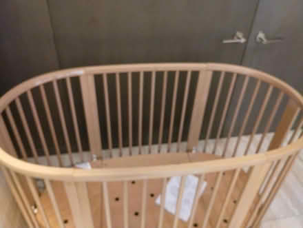 Photo of free Light brown wood oval crib, wheels (Upper West side) #1