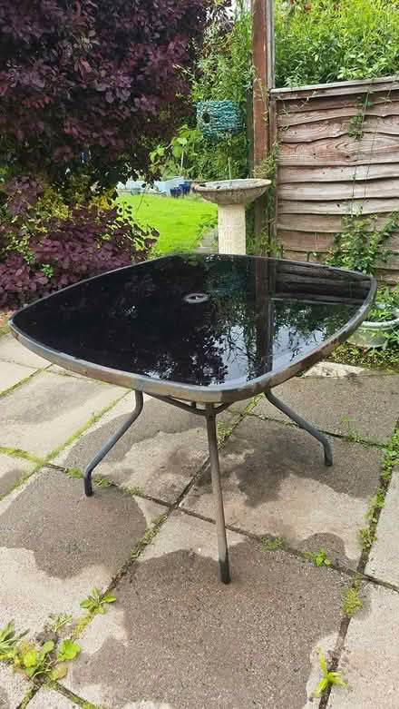 Photo of free Black Glass patio table (Cambuslang, Glasgow G72) #1