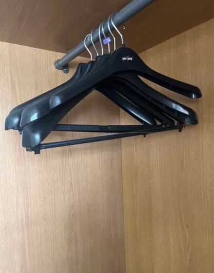 Photo of free 7x wide black plastic hangers (Newburgh WN8) #1
