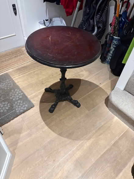 Photo of free Round side table dark wood. Metal stand. Heavy to carry. (Chiswick W4) #2