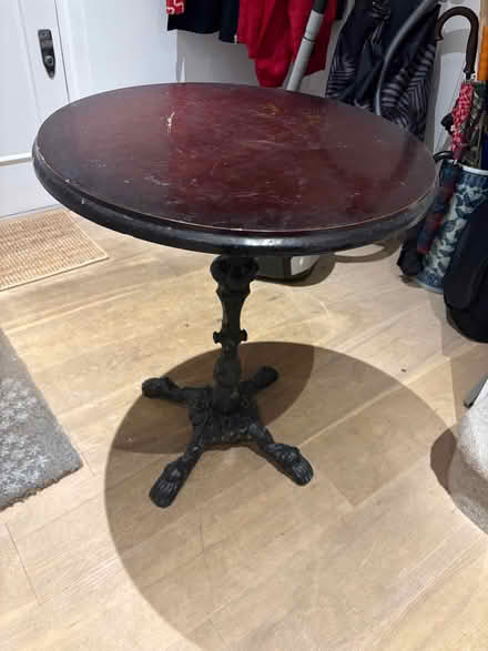 Photo of free Round side table dark wood. Metal stand. Heavy to carry. (Chiswick W4) #1