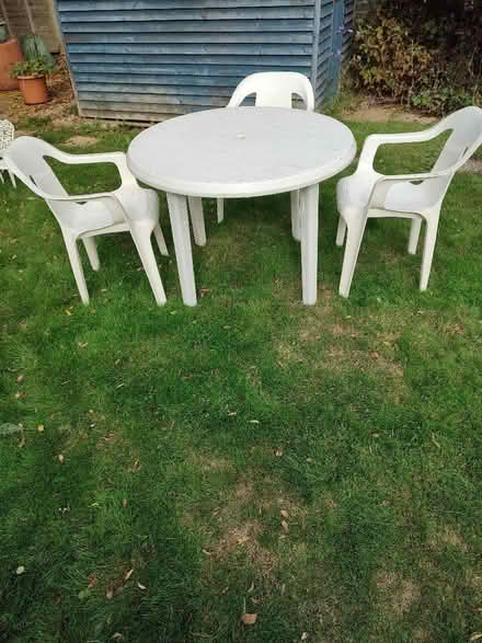 Photo of free White plastic patio table and 3 chairs (Sidley TN40) #1