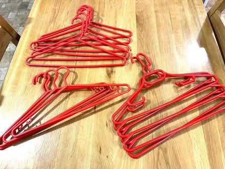 Photo of free 12 STRONG red plastic hangers (Hucclecote GL3) #1