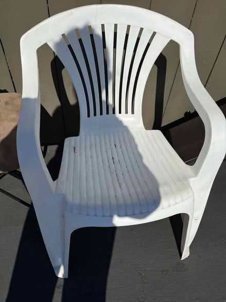 Photo of free White plastic chair with arm rests (Valencia Avenue, Sunnyvale) #1