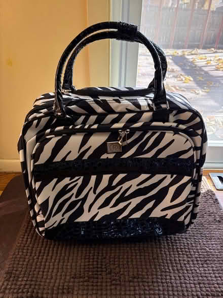 Photo of free Zebra striped rolling bag (S Garland St and W Yale Ave) #1