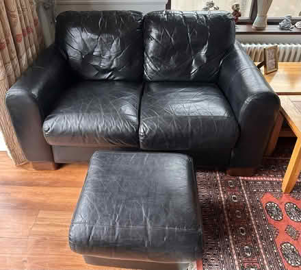 Photo of free Black Leather Two Seat Sofa & Footstool (Cassiobury WD17) #1