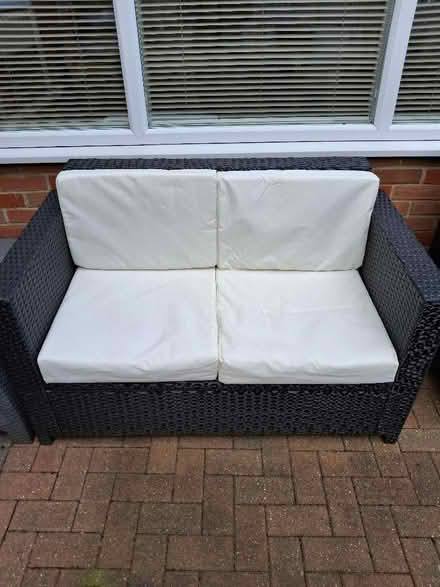 Photo of free 2 seater garden ratten sofa with cushions good condition (Shenley WD7) #1