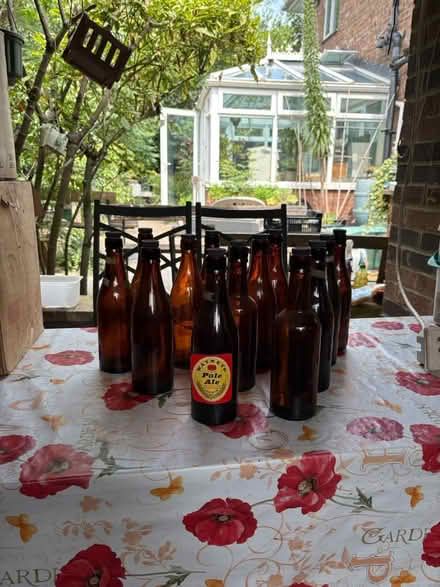 Photo of free 23 one pint screw top beer bottles (London W3) #1